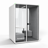 Angled view of FocusPod Duo in Arctic White showing the glass front, side panel and optional two-bench furniture package.