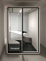 FocusPod Duo installed indoors with two benches, shared table, red corner indicators and FocusPod sticker low on the left glass.