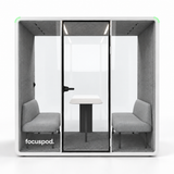FocusPod Meet front studio view with optional four-person sofa furniture package and low left glass logo.
