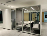 FocusPod Meet installed in an office with the white FocusPod logo low on the left glass.