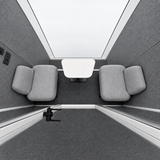 FocusPod Team top-down interior view of two upholstered seats and central coffee table.
